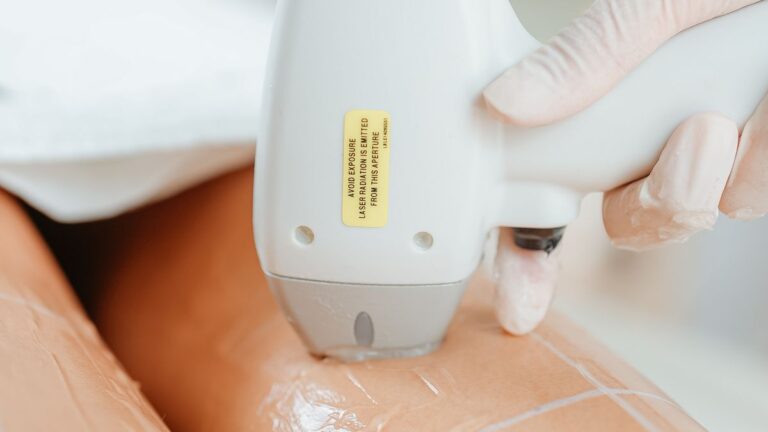 Laser hair removal treatment being performed on a leg in a clinic, illustrating whether laser hair removal hurts