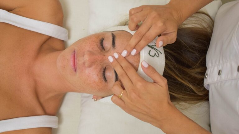 Woman receiving a relaxing facial massage with eyes closed, illustrating facial massage for wrinkles