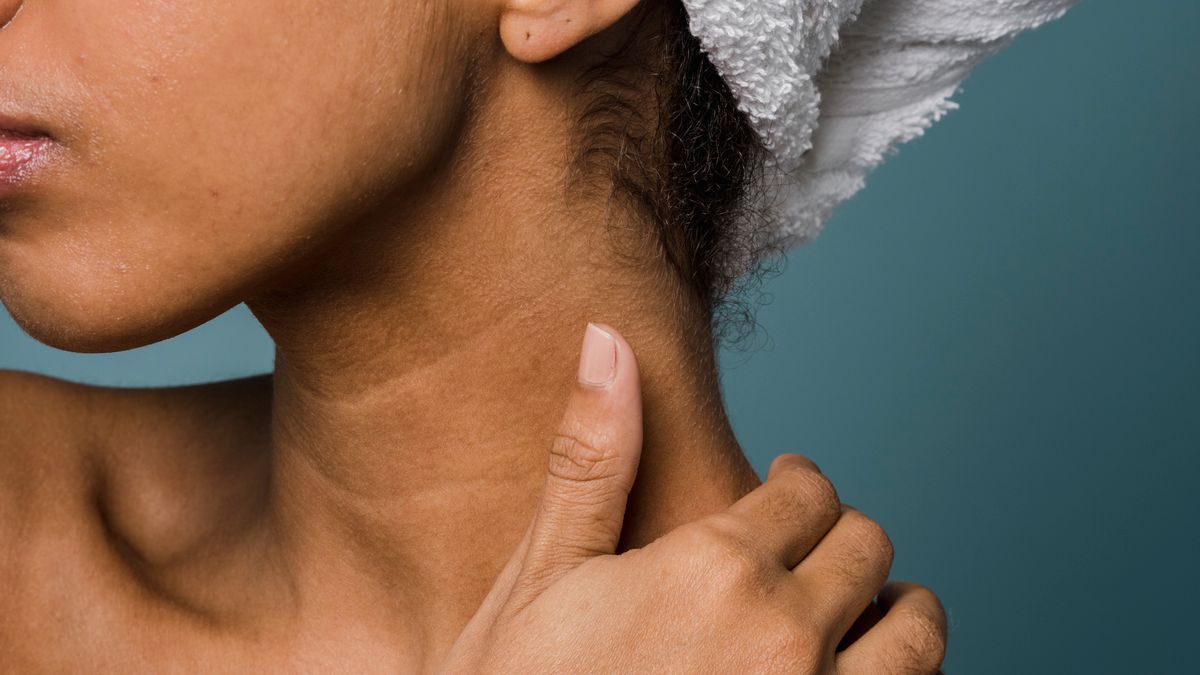 Woman with smooth skin and a towel on her head after showering, illustrating how to get rid of ingrown pubic hair