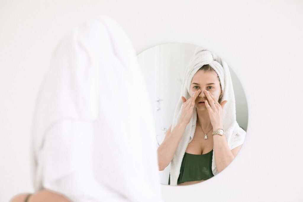 Woman doing a gentle skincare routine, representing the mild, temporary IPL side effects most people get