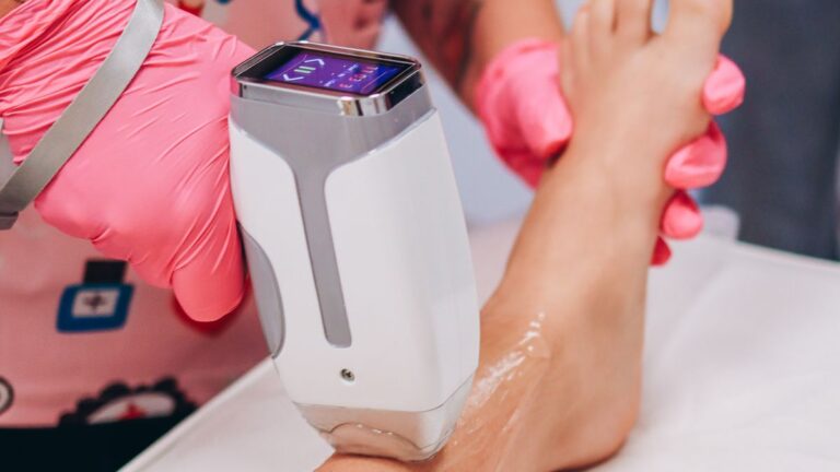Laser hair removal session on a leg in a clinic, illustrating IPL vs laser hair removal