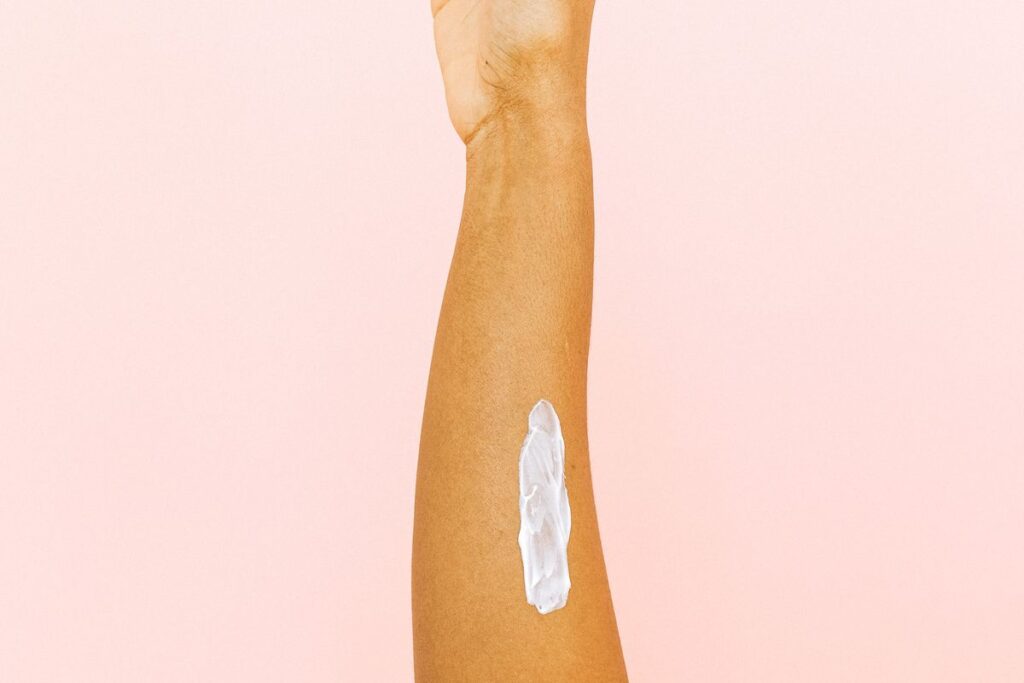 Close-up of a forearm with lotion, showing where keratosis pilaris chicken skin appears